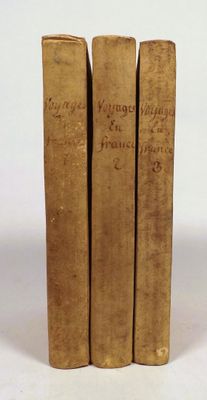 three old books sitting on top of each other on a white surface