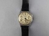 a close up of a wrist watch on a white surface