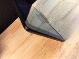 a laptop computer sitting on top of a wooden table