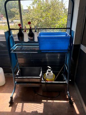 a blue cart with a blue container on top of it