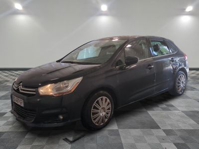 the black car is parked in the garage on the checkered floor