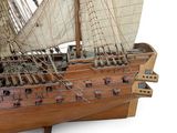 a wooden model of a boat with sails on a stand