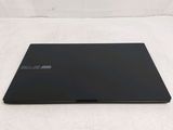 the back of a black laptop computer sitting on top of a white surface