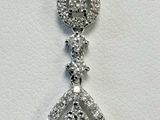 a white gold diamond necklace with a tear shaped pendant on a chain