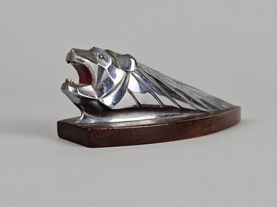 une sculpture en argent représentant un ours la gueule ouverte