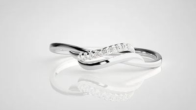a white gold ring with diamonds on a reflective surface