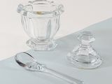 a glass bowl and a spoon on a table