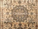 a beige and blue rug with a medallion design on it