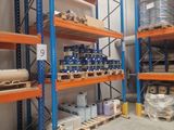 many shelves in the warehouse with various items on them