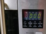 a close up of a digital clock on a microwave