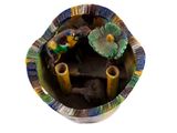 a small bowl with a bird on top of it