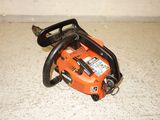 an image of a chainsaw that is on the ground