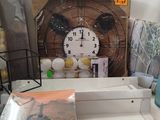 a table with a clock, books, and other items on it