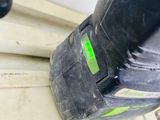 two electric tools sitting on top of a wooden floor next to a door