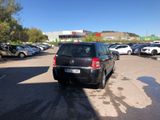 a black car parked in a parking lot next to other cars
