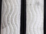 a close up of a person holding a mattress in their hand