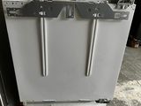 a white dishwasher sitting on a pallet in a garage