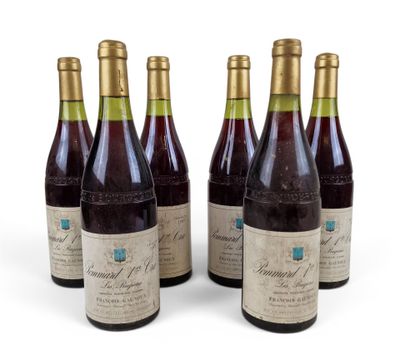 six bottles of wine sitting next to each other on a white surface