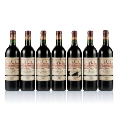 six bottles of wine are lined up on a white surface