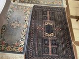 two rugs that are on the floor in the room