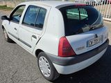 a small white car parked on the side of the road