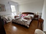 a bedroom with a bed and a chair in it