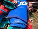 a pile of blue, red, and green bags on the ground