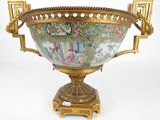 a large ornate vase on a stand on a white surface