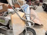 a pile of junk in a garage next to a truck