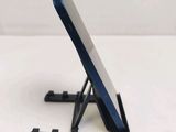 a cell phone sitting on a stand on a table