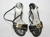Sandales en cuir noir Michael Korsch avec des détails dorés