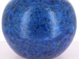 a blue vase that is sitting on a table