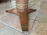 a close up of a wooden table on a tiled floor