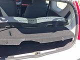 a white car with its trunk open and a dog in the back seat