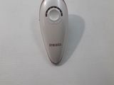 a close up of a remote control on a white surface