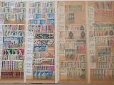 an open book with stamps on it sitting on top of a table
