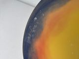 a person holding a colorful plate with writing on it
