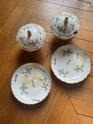 four pieces of china on a wooden floor with a wooden table