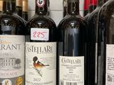 several bottles of wine are lined up on a shelf