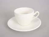 a white cup and saucer sitting on a saucer
