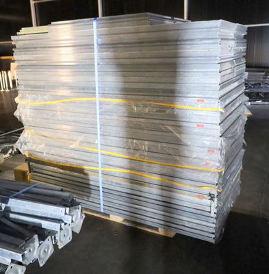 several stacks of steel bars stacked on top of each other in a warehouse