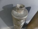 two metal cylinders sitting next to each other on a table