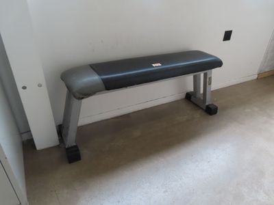 a bench in the corner of a room with a window