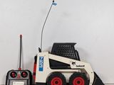 a small toy ski - loader with a radio on top of it