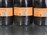 three bottles of wine are lined up on a glass table