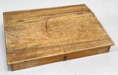 an old wooden box sitting on top of a white table