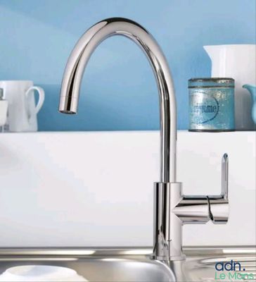 a kitchen sink with a faucet and dishes on the counter