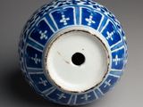 a blue and white vase sitting on a table