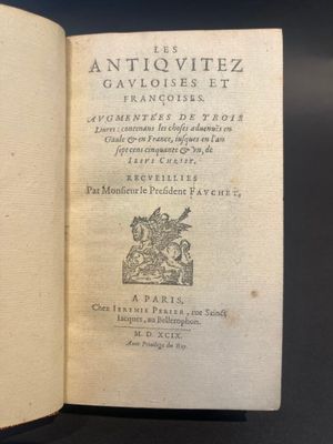 an open book on a table with a black background