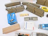 a lot of train tracks and a box of train parts